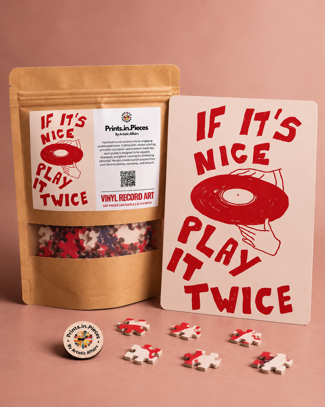If It's Nice Play It Twice jigsaw puzzle – hand holding vinyl record in red and blush